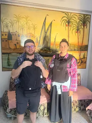 a man and a woman standing in front of a painting at SEO House in Aswan
