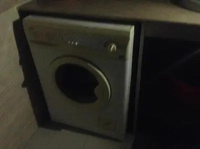 a washing machine sitting on the floor in a bathroom at Luxor Stables Apartment in Luxor