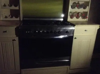 a black stove top oven in a kitchen at Luxor Stables Apartment in Luxor