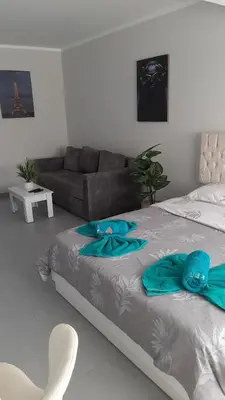a bedroom with a bed with blue pillows on it at Hurghada Ägypten Scandic Resort in Hurghada