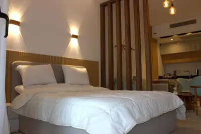 a bedroom with a large white bed with lights on it at Fully equipped studio Sahl Hasheesh in Hurghada