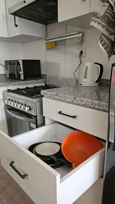 a kitchen with a drawer with a pot in it at Fully equipped studio Sahl Hasheesh in Hurghada