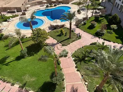 an overhead view of a resort with palm trees and a pool at Fully equipped studio Sahl Hasheesh in Hurghada