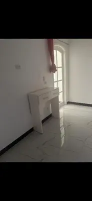 a white room with a white desk and a window at King mou in ‘Ezbet Abu Ḥabashi
