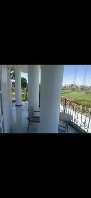 a room with two chairs and a balcony with a view at King mou in ‘Ezbet Abu Ḥabashi