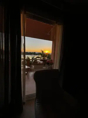 a room with a window with a view of the sunset at The Sunset Heaven - 2 bedrooms - Golf Steigenberger, El Gouna in Hurghada