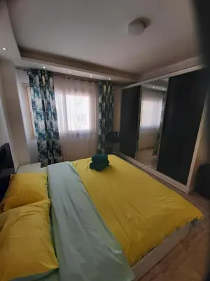 a large bed in a bedroom with a large mirror at SKY EL Gandoul Wohnung Hurghada in Hurghada