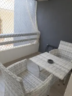a table and two chairs and a table and a table at SKY EL Gandoul Wohnung Hurghada in Hurghada