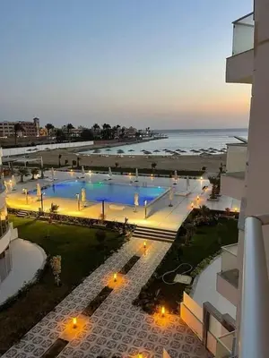 a view of a swimming pool next to a beach at Scandic sea view in Hurghada