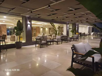a lobby with chairs and tables in a building at Fanadir bay resort in Hurghada