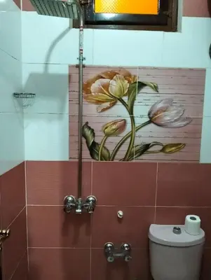 a bathroom with a painting of flowers on the wall at elephantine nile view house in Aswan