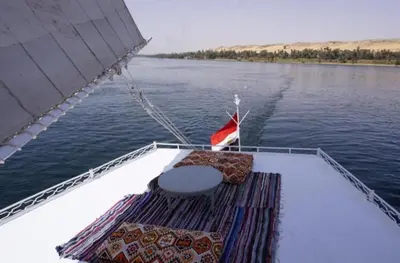 a seat on the back of a boat on the water at elephantine nile view house in Aswan