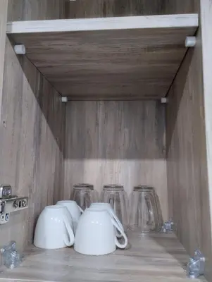 a shelf with four tea pots and glasses on it at scandic in Hurghada