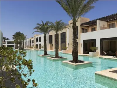 a swimming pool with palm trees in a resort at Serene Pool View 8Mins to Marina in Hurghada