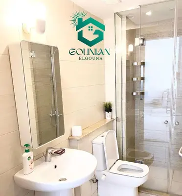 a bathroom with a white toilet and a sink at El Gouna -G-cribs B6 in El Gouna