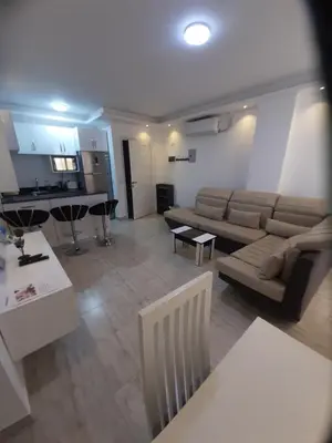 a living room with a couch and a table at Wohnung SKY EL Gandoul in Hurghada