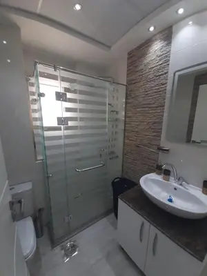 a bathroom with a shower and a sink and a toilet at Wohnung SKY EL Gandoul in Hurghada