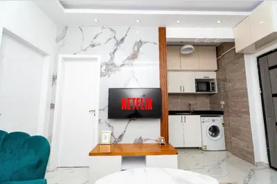 a kitchen with a tv on a wall at Hurghada apartment luxury 002 in Hurghada