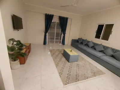 a living room with a couch and a table at Al Hayat house in Luxor