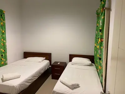 two beds in a small room withskirts at Luxury Stays in Waterside El Gouna in Hurghada