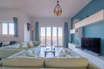 a living room with two couches and a tv at Luxury Stays in Waterside El Gouna in Hurghada