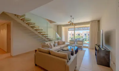 a living room with a couch and a staircase at Luxury Stays in Mangroovy El Gouna in Hurghada