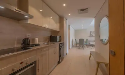 a kitchen with a sink and a stove top oven at Luxury Stays in Mangroovy El Gouna in Hurghada