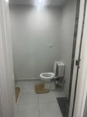 a bathroom with a white toilet in a stall at scandic resort in Hurghada