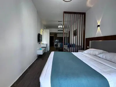 a bedroom with a large bed with a blue blanket at Al Saraya Sahl Hasheesh by Peaks in Hurghada