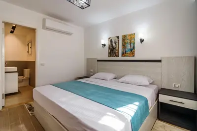 a bedroom with a large bed and a bathroom at Al Saraya Sahl Hasheesh by Peaks in Hurghada