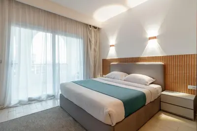 a bedroom with a large bed and a large window at Al Saraya Sahl Hasheesh by Peaks in Hurghada