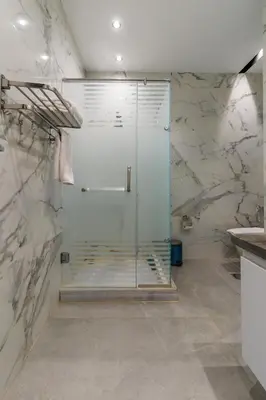 a bathroom with a glass shower and a sink at Al Saraya Sahl Hasheesh by Peaks in Hurghada