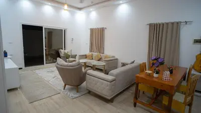a living room with a couch and chairs and a table at hodhod luxor in Al Qurnah