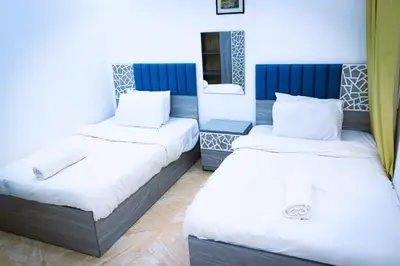 a room with two beds and a mirror at selena bay resort in Hurghada