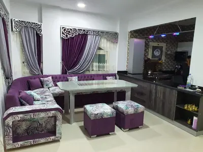 a living room with a purple couch and a table at منتجع لاكشيري جميع الرفاهيات و الكماليات in Hurghada