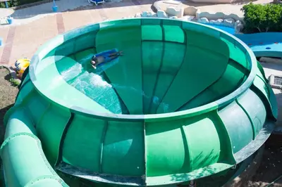 a person riding a water slide at a water park at Titanic Aqua Park Resort - Families and Couples only in Hurghada