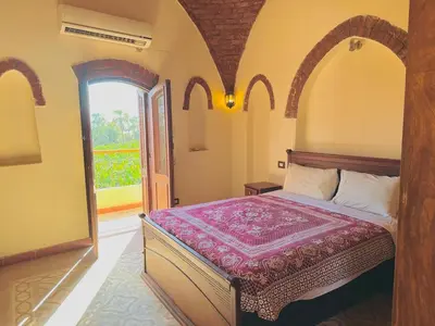 a bedroom with a bed in a room with a window at King Tut in Luxor
