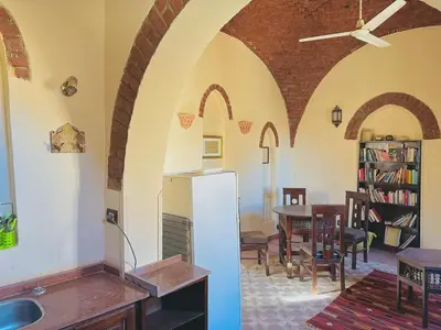a kitchen and dining room with a white refrigerator at King Tut in Luxor