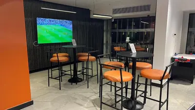 a bar with stools and a tv in a room at Flow Spectrum Resort Sahl Hasheesh in Hurghada
