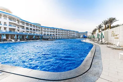 a swimming pool in front of a resort at Flow Spectrum Resort Sahl Hasheesh in Hurghada
