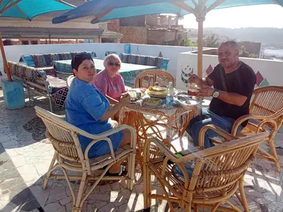 a group of people sitting at a table at dahab in Aswan