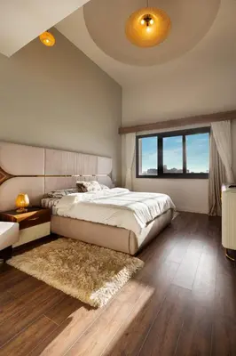 a bedroom with a bed and a large window at Fanadir Marina Front Penthouse with Pool in Hurghada