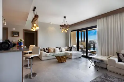 a living room with a couch and a table at Fanadir Marina Front Penthouse with Pool in Hurghada
