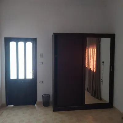 a mirror in front of a door in a room at Villa River Nile in Al Qurnah