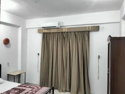 a bedroom with a bed and a curtain at Villa River Nile in Al Qurnah