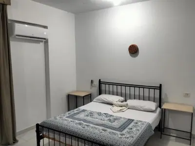 a bedroom with a bed with a towel on it at Villa River Nile in Al Qurnah