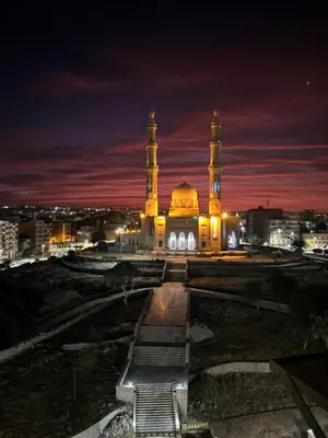 a large building with a mosque at night at Aswan apartment-Center of Aswan in Aswan