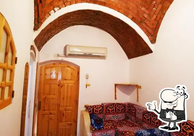 a bedroom with a bed with a cartoon on the wall at Ibiza Guest House in Aswan
