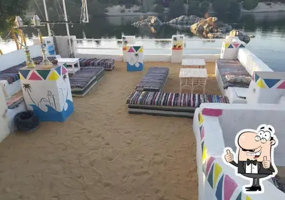 a beach with chaise lounges on the sand at Ibiza Guest House in Aswan