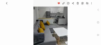 a living room with a couch and yellow pillows at Spacious and modern one bed in hurhgarda in Hurghada